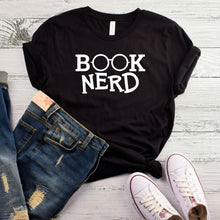 Load image into Gallery viewer, If you love to read books this shirt is for you. Get cozy and snug with hot coco and a book. Style this with your favorite denim jeans, high heels and handbag for a effortless outfit of the day.
